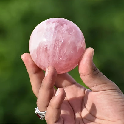 A large rose quartz crystal ball - a deep pink bohemian sphere, perfect for weddings and Valentine's Day decorations.