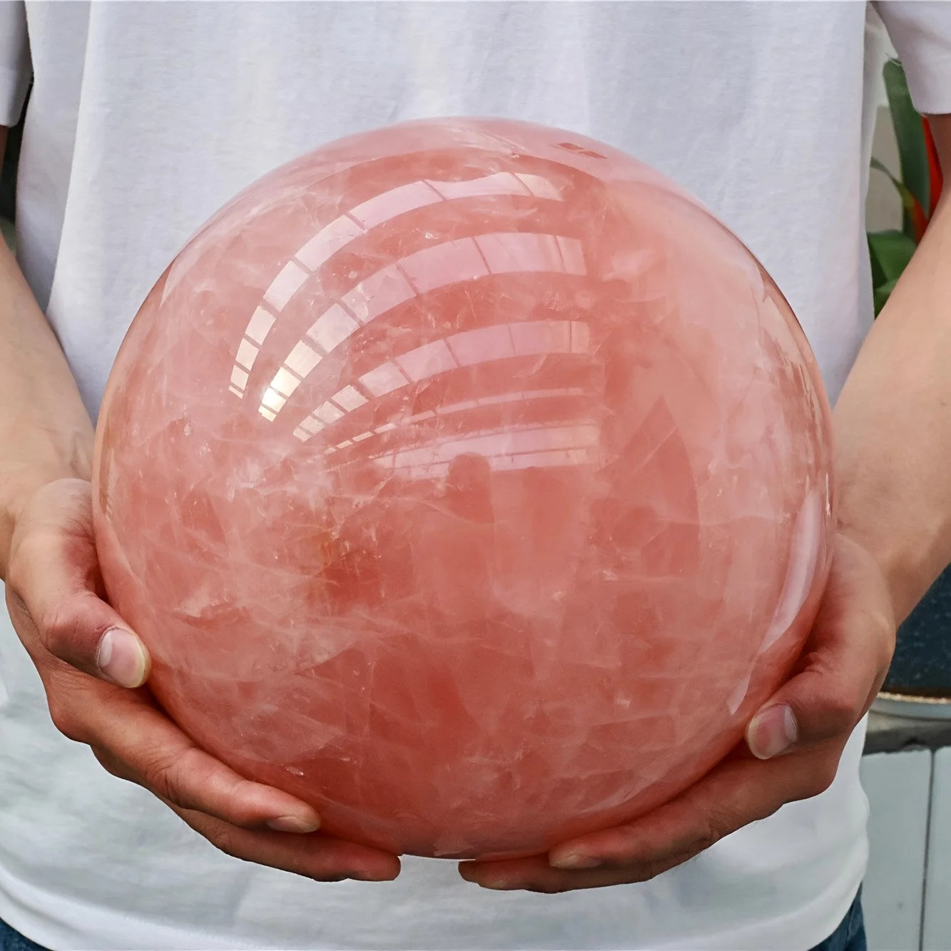 A large rose quartz crystal ball - a deep pink bohemian sphere, perfect for weddings and Valentine's Day decorations.