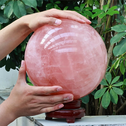 A large rose quartz crystal ball - a deep pink bohemian sphere, perfect for weddings and Valentine's Day decorations.