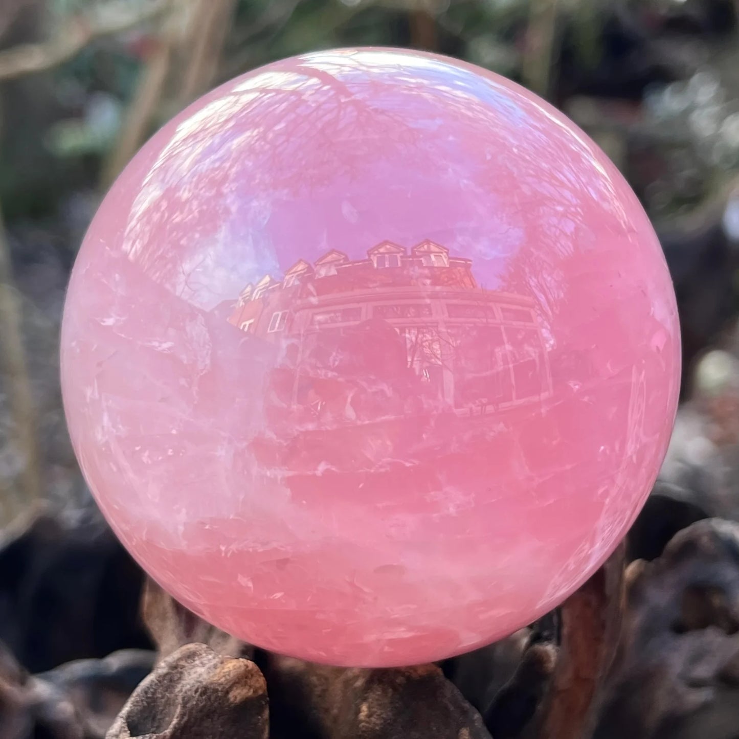 A large rose quartz crystal ball - a deep pink bohemian sphere, perfect for weddings and Valentine's Day decorations.