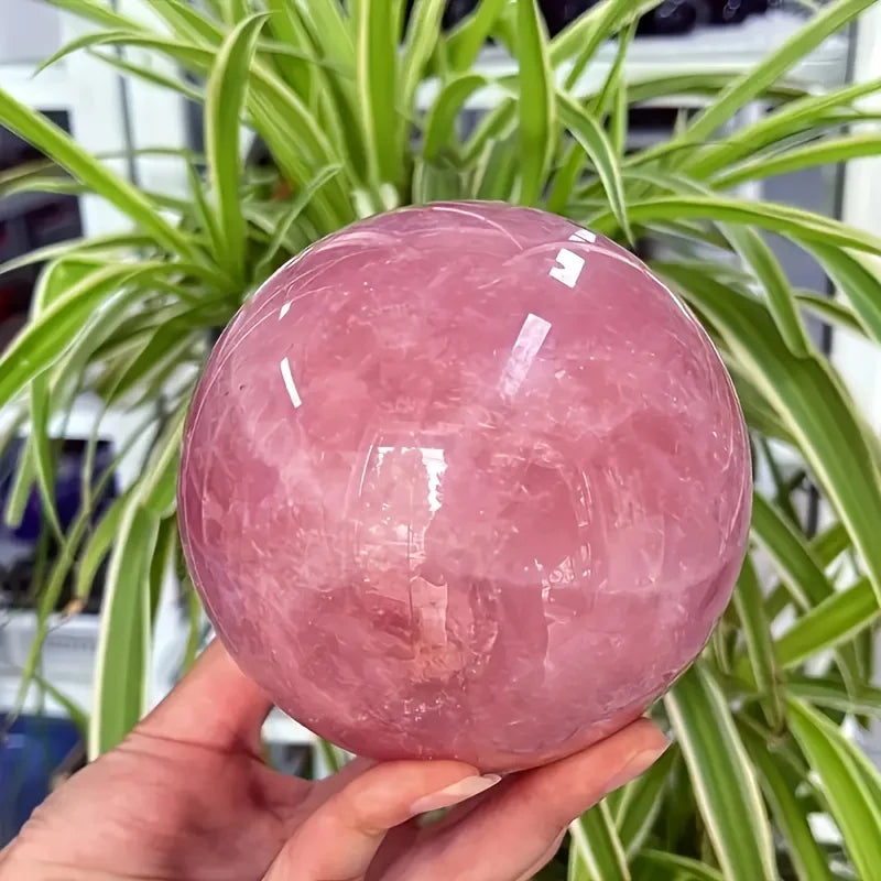 A large rose quartz crystal ball - a deep pink bohemian sphere, perfect for weddings and Valentine's Day decorations.