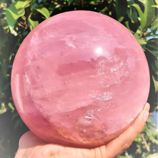 A large rose quartz crystal ball - a deep pink bohemian sphere, perfect for weddings and Valentine's Day decorations.
