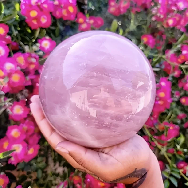 A large rose quartz crystal ball - a deep pink bohemian sphere, perfect for weddings and Valentine's Day decorations.