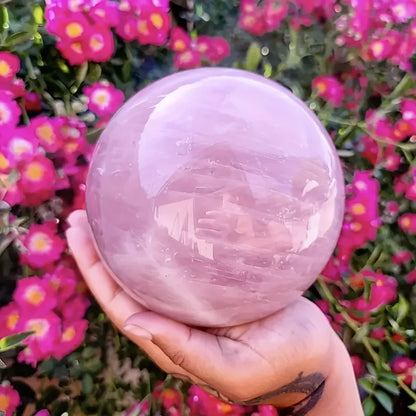 A large rose quartz crystal ball - a deep pink bohemian sphere, perfect for weddings and Valentine's Day decorations.