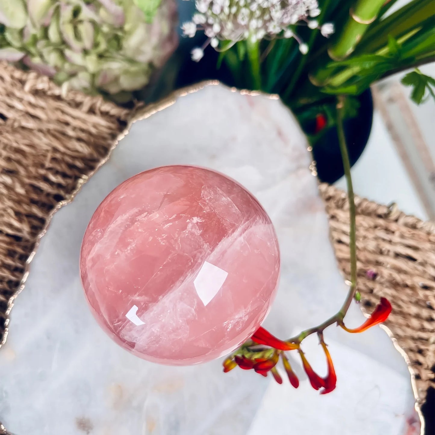 A large rose quartz crystal ball - a deep pink bohemian sphere, perfect for weddings and Valentine's Day decorations.